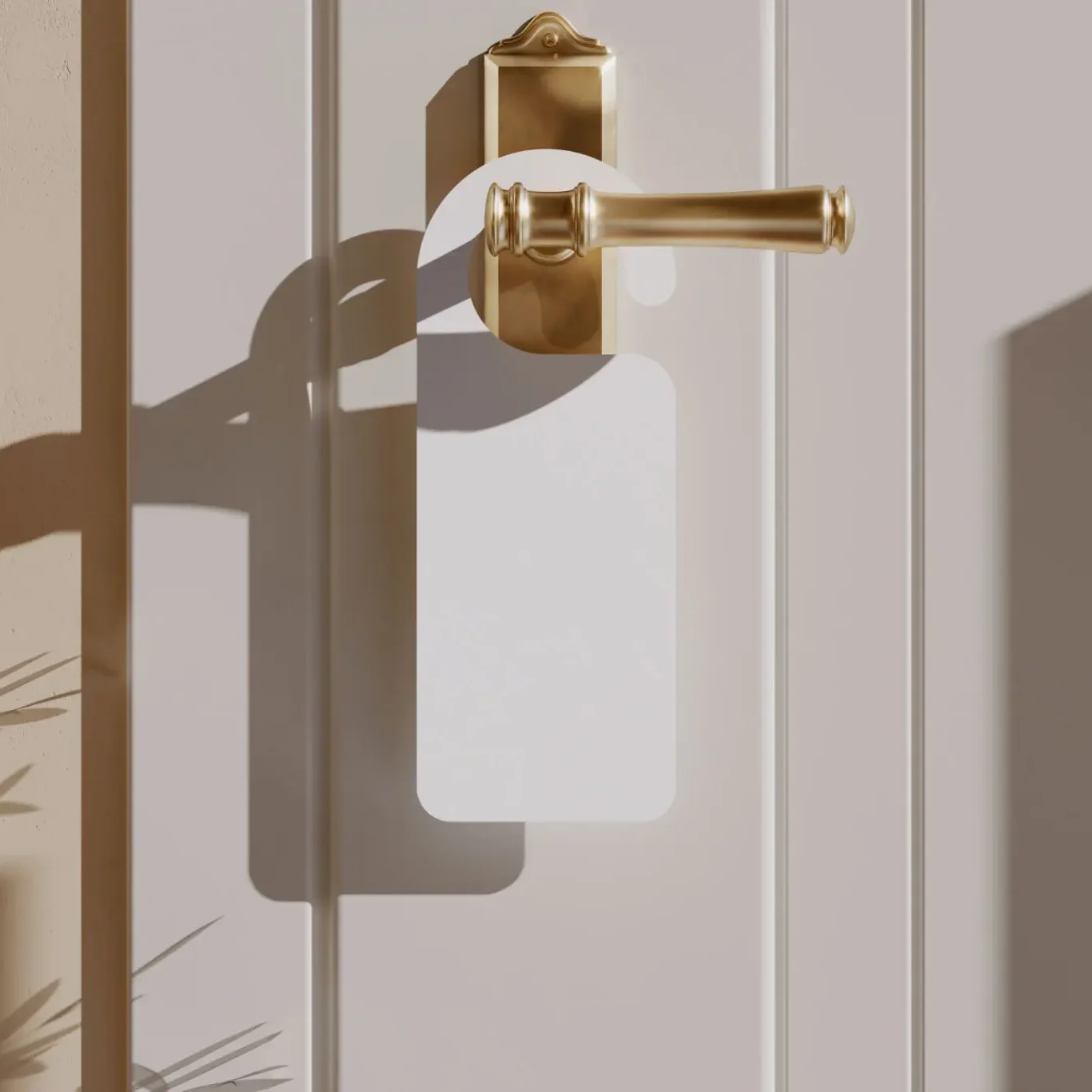 White door hanger on a golden door handle casting a shadow.