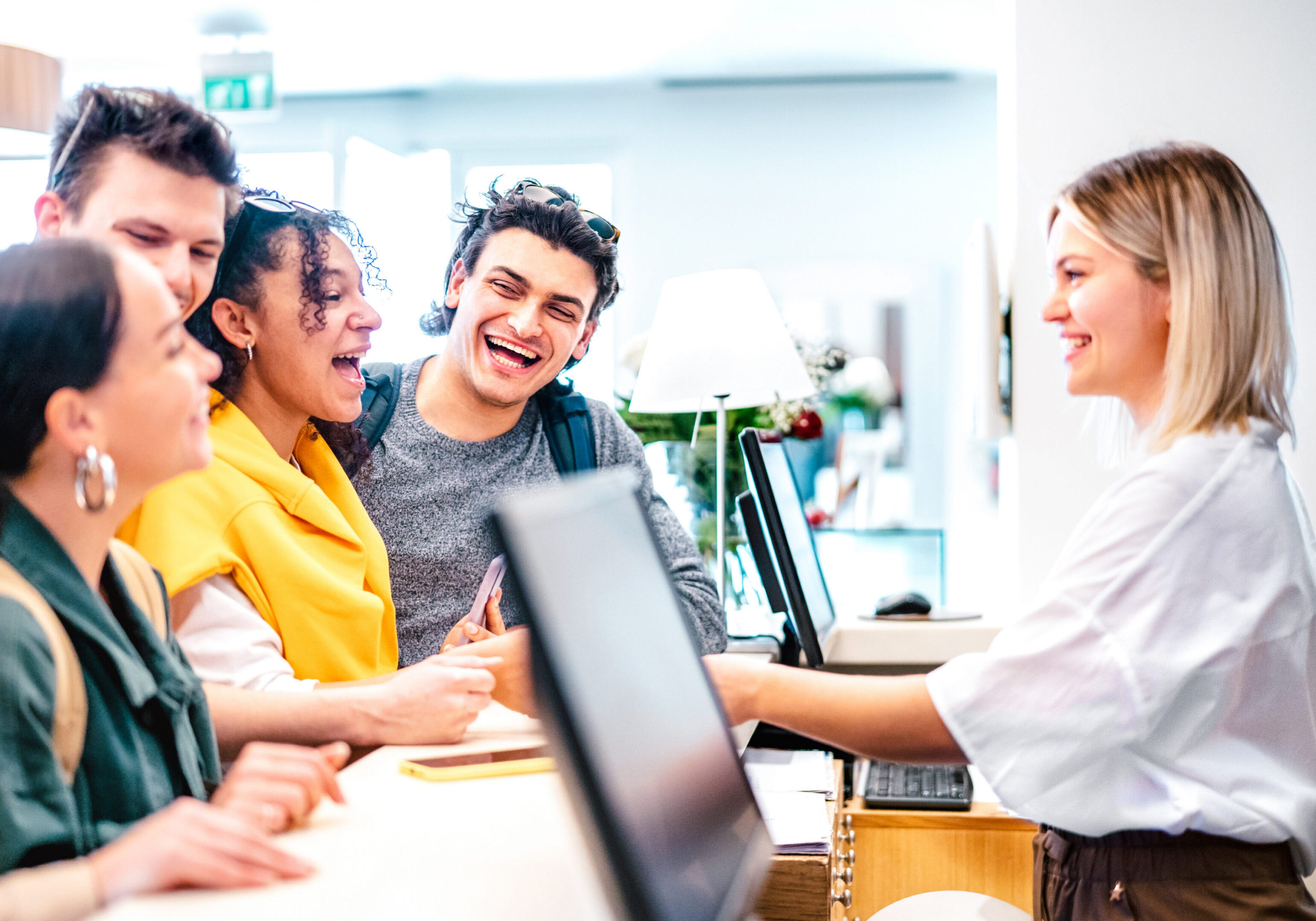Group of young professionals collaborating happily in an office setting.
